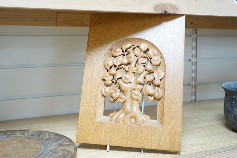 A pair of Roger Sutton carved oak panels depicting pear and oak trees and a bread board ‘Maketh Man Manners, largest 44cm wide. Condition - good (3)